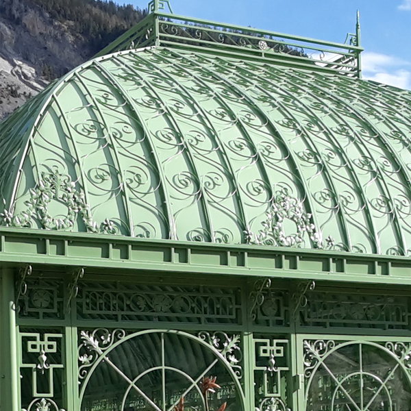 Victorian greenhouse domed roof with elaborate scroll‑work decorative metal ornament