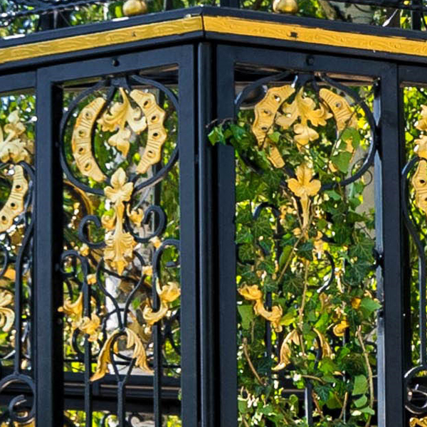 Black iron side panel with golden floral scroll cutout decor for wedding gazebo