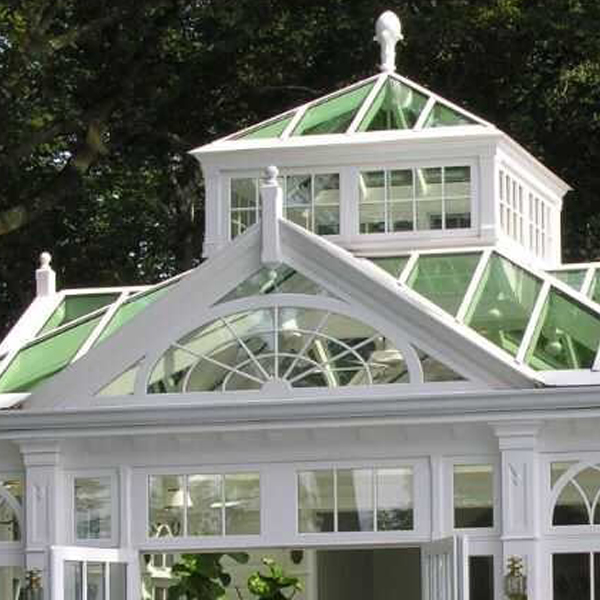 Close‑up view of cupola roof and arched decorative glass gable of Victorian sunroom