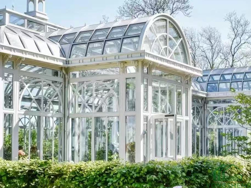 Close‑up view of arched dome and ornate grille details of steel glass conservatory