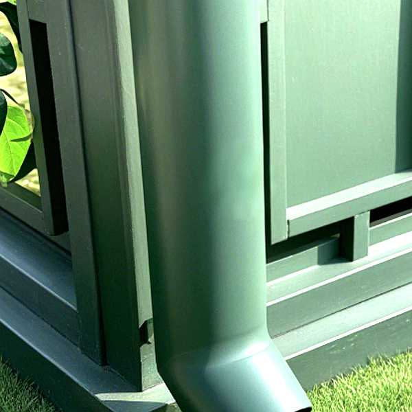 Close‑up detail of victorian greenhouse steel frame and rain gutter system