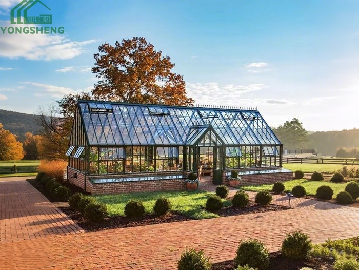 Luxury dark steel Victorian greenhouse on countryside estate