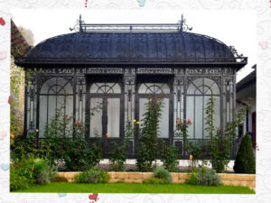 Black Victorian greenhouse with hot-dip galvanized steel frame in a garden setting