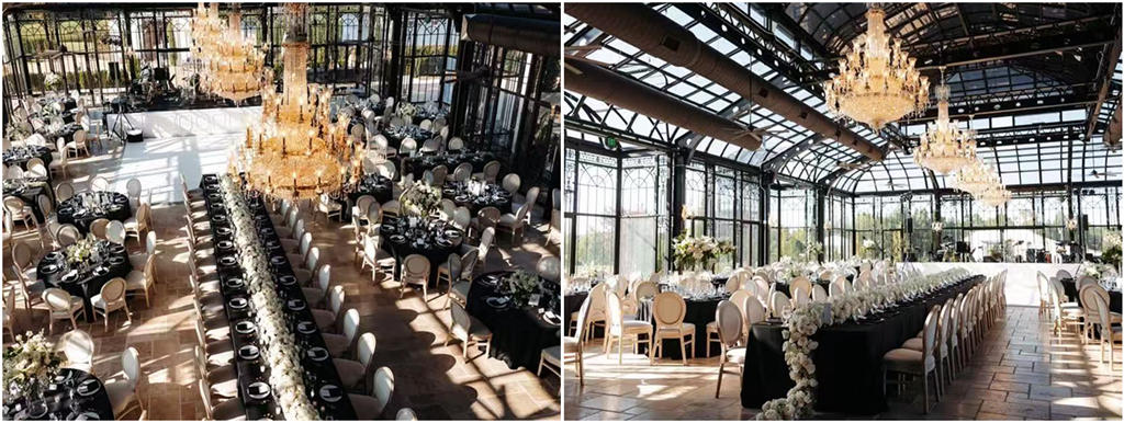 A reception setup inside a Victorian greenhouse, with twinkling lights and long wooden tables