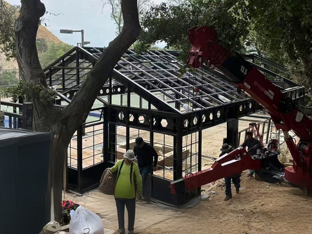 Steel frame installation for victorian glass conservatory on site