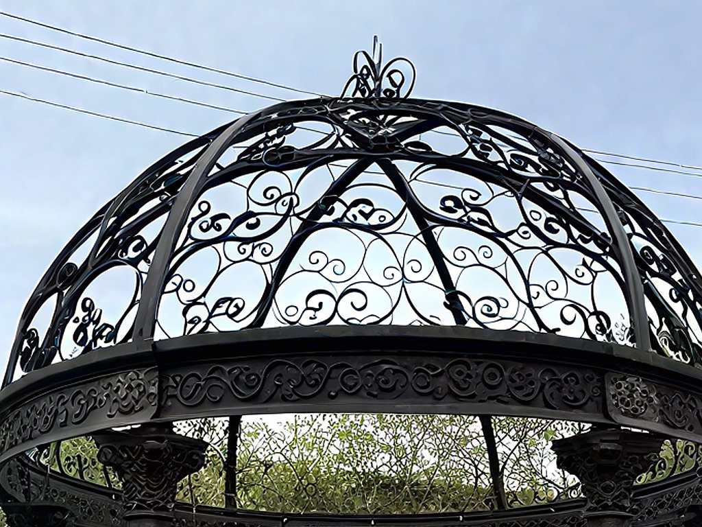 Low‑angle shot of openwork wrought‑iron dome roof for cast iron gazebo