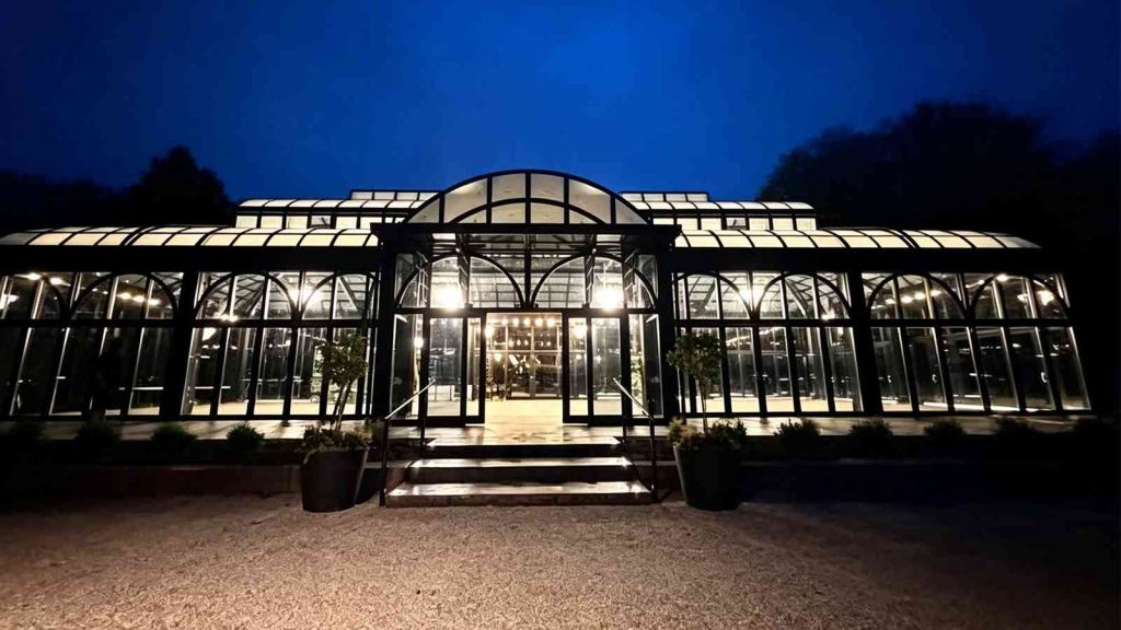 Night exterior view of Victorian conservatory, illuminated black steel glass facade, finished project in New Franklin, Ohio