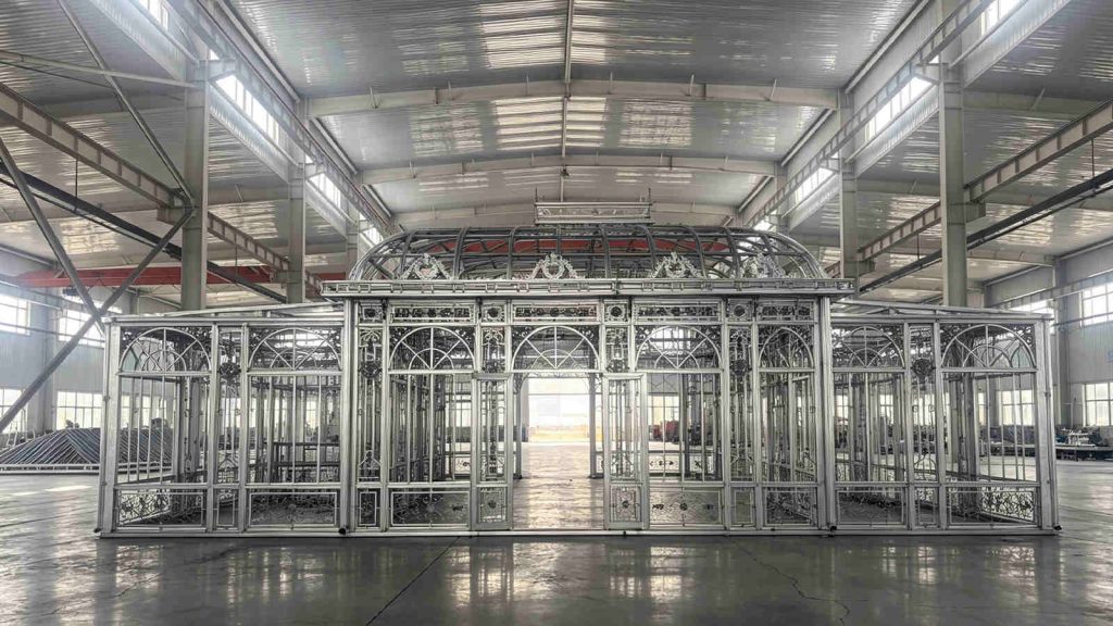 Clean symmetrical front shot of the completed Victorian greenhouse frame ready for final testing inside the manufacturing workshop.