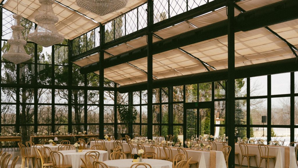 Large commercial conservatory sunroom side view，black steel frame with fabric retractable ceiling and crystal chandeliers