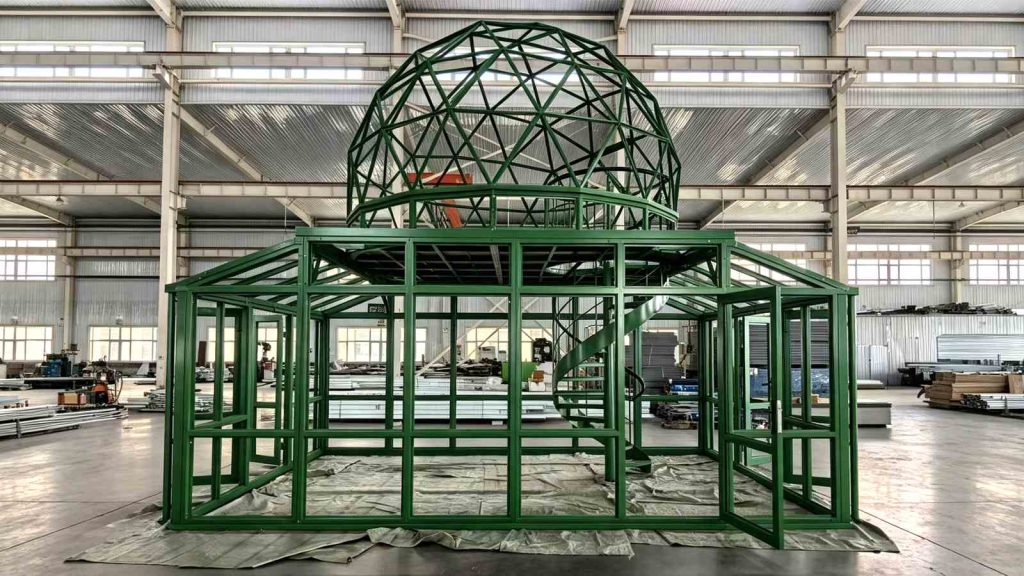  Front view of green geodesic dome sunroom frame with built-in spiral staircase