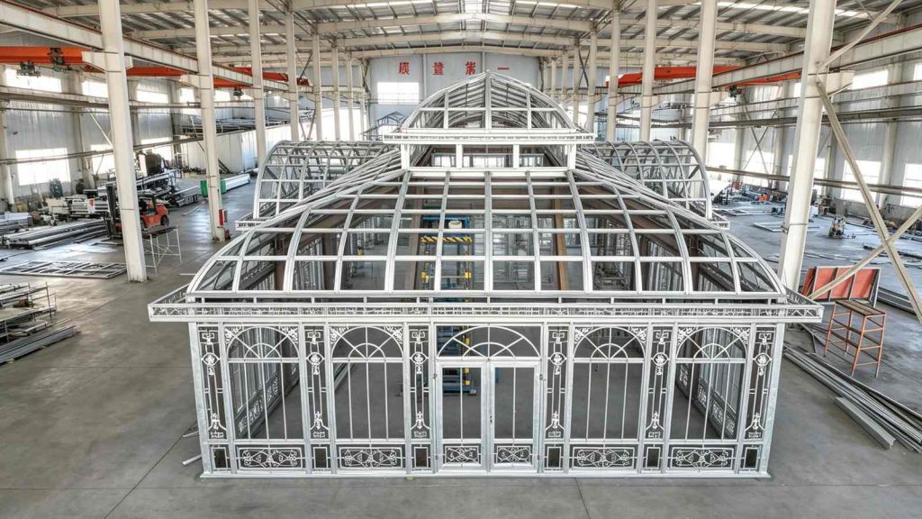 Aerial top view of big custom Victorian conservatory frame during factory trial assembly, grand arched roof and decorative window grilles