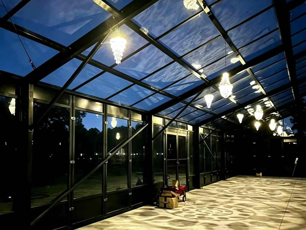 South Carolina wedding venue interior with glass walls and PC roof, hanging crystal chandeliers